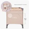A beige travel crib with a leaf pattern on the top edge, shown with a close-up inset highlighting a zippered side entrance and a dimension indicator. Náhled obrázku produktu