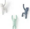Three wall hooks shaped like climbing figures in different colors. Náhled obrázku produktu