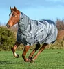 A horse wearing a blanket runs in a grassy field. Voir les images du produit