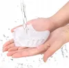Hands holding a white gel separator under running water. Podgląd zdjęcia produktu
