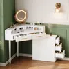 A white corner vanity desk with a lighted mirror and drawers, set against a green wall. Podgląd zdjęcia produktu