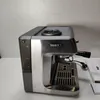 A side view of a silver espresso machine on a light gray background. Produktbild-Vorschau