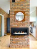 A modern living room with a brick fireplace and a black ethanol fireplace. Anteprima dell’immagine prodotto