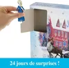 A hand holding a small Elsa doll in front of an open advent calendar. Produktbild-Vorschau