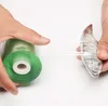 Hands are shown wrapping a plant stem with transparent grafting tape from a green roll. Produktbild-Vorschau