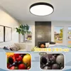 A living room with a ceiling light, fireplace, and furniture, with two inset images of fruit. Produktbild-Vorschau