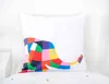 A white pillow with a colorful patchwork elephant design is placed on a white bed. Produktbild-Vorschau
