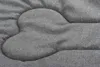 A close-up view of a quilted dog bed with a bone-shaped pattern. Náhľad obrázku produktu