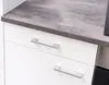 Close-up view of kitchen cabinets with a gray countertop and silver handles. Náhled obrázku produktu