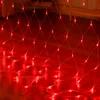 A close-up shot of red net lights draped over a wooden floor. Produktbild-Vorschau