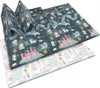 A folded play mat with a fantasy theme, showing castles, dragons, and fairy-tale characters. Podgląd zdjęcia produktu