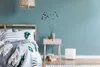 A bedroom scene with a bed, nightstand, and a humidifier. Produktbild-Vorschau