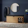 An entryway with a shoe cabinet, mirror, coat hooks, and a rug. Produktbild-Vorschau