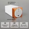 The back of a white and copper LED night light is shown with labels indicating battery compartment and light switch functions. Voir les images du produit