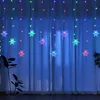 A string of snowflake-shaped LED lights hanging in front of a white curtain. Náhled obrázku produktu