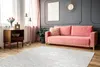 A living room scene with a pink sofa, a wooden cabinet, and a rug. Produktbild-Vorschau