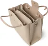 A top-down view of an open beige handbag. Náhled obrázku produktu