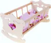 A wooden doll cradle with pink bedding. Náhľad obrázku produktu