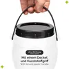 A hand holding a white plastic container with a black lid and handle. Produktbild-Vorschau