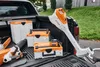 Power tools and storage boxes are arranged in the bed of a pickup truck. Produktbild-Vorschau