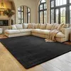 A living room with a large sectional sofa and a black rug. Podgląd zdjęcia produktu