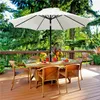 An outdoor patio set with a table, chairs, and an umbrella, surrounded by trees and greenery. Produktbild-Vorschau