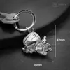 A close-up shot of a silver angel keychain with a clover, placed on a dark, textured surface. Dimensions are indicated by white lines and text. Produktbild-Vorschau