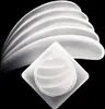 A product shot of several white curved objects stacked on top of each other, with a small square container in the foreground. Anteprima dell’immagine prodotto