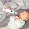 A person is holding a white and green electronic nasal aspirator near a baby lying on a gray surface. Anteprima dell’immagine prodotto