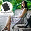 A woman is sitting on a park bench with a cushion under her. Produktbild-Vorschau