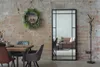 A dining area with a mirror, chairs, and a table against a brick wall. Produktbild-Vorschau
