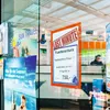 A travel agency window display with various brochures and a "Last Minute" offer sign. Podgląd zdjęcia produktu