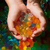Hands holding colorful gel beads. Náhled obrázku produktu