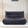A dark gray sofa is shown in the center of the image against a white wall with decorative molding. Produktbild-Vorschau