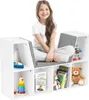 A young girl sits on a white storage unit with gray cushions, surrounded by toys and books. Podgląd zdjęcia produktu