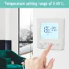 A hand is shown adjusting a digital thermostat mounted on a wall. Náhľad obrázku produktu