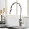 A stainless steel kitchen faucet with a pull-down sprayer is shown in a kitchen setting. Produktbild-Vorschau