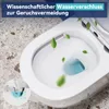 A close-up view of a white toilet bowl with green leaves floating around it, and a diagram showing the water seal mechanism. Náhled obrázku produktu