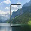 A smartphone displaying a scenic mountain landscape is placed in front of a blurred background of mountains and a lake. Anteprima dell’immagine prodotto