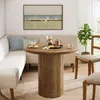A dining set with a round wooden table and chairs, a banquette, and a painting on the wall. Produktbild-Vorschau