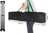 A person is carrying a folded tent in a black carrying bag over their shoulder. The tent frame is shown on the left side of the image. Náhled obrázku produktu