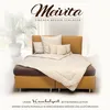 A bed with pillows and a duvet, set in a room with a plant and curtains. Produktbild-Vorschau