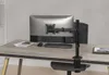 A monitor arm mounted on a desk, holding a computer monitor. Produktbild-Vorschau