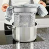 A person is using a steamer insert in a pot on a stovetop. Náhľad obrázku produktu