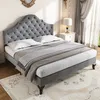A tufted velvet bed with bedding in a well-lit room. Produktbild-Vorschau
