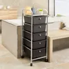 A bathroom with a bathtub, vanity, and a rolling storage cart with black drawers. Produktbild-Vorschau