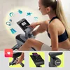 A woman is using a stationary bike, interacting with the console. The image is divided into sections showcasing different features. Produktbild-Vorschau