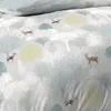 A close-up view of a duvet cover with a forest and deer pattern. Produktbild-Vorschau