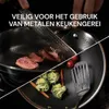 A split image showing a frying pan with meat being cooked on one side and vegetables on the other, with text overlay. Náhľad obrázku produktu