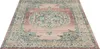 A square rug with a vintage-inspired pattern is shown from a diagonal, slightly elevated angle on a white background. Náhled obrázku produktu